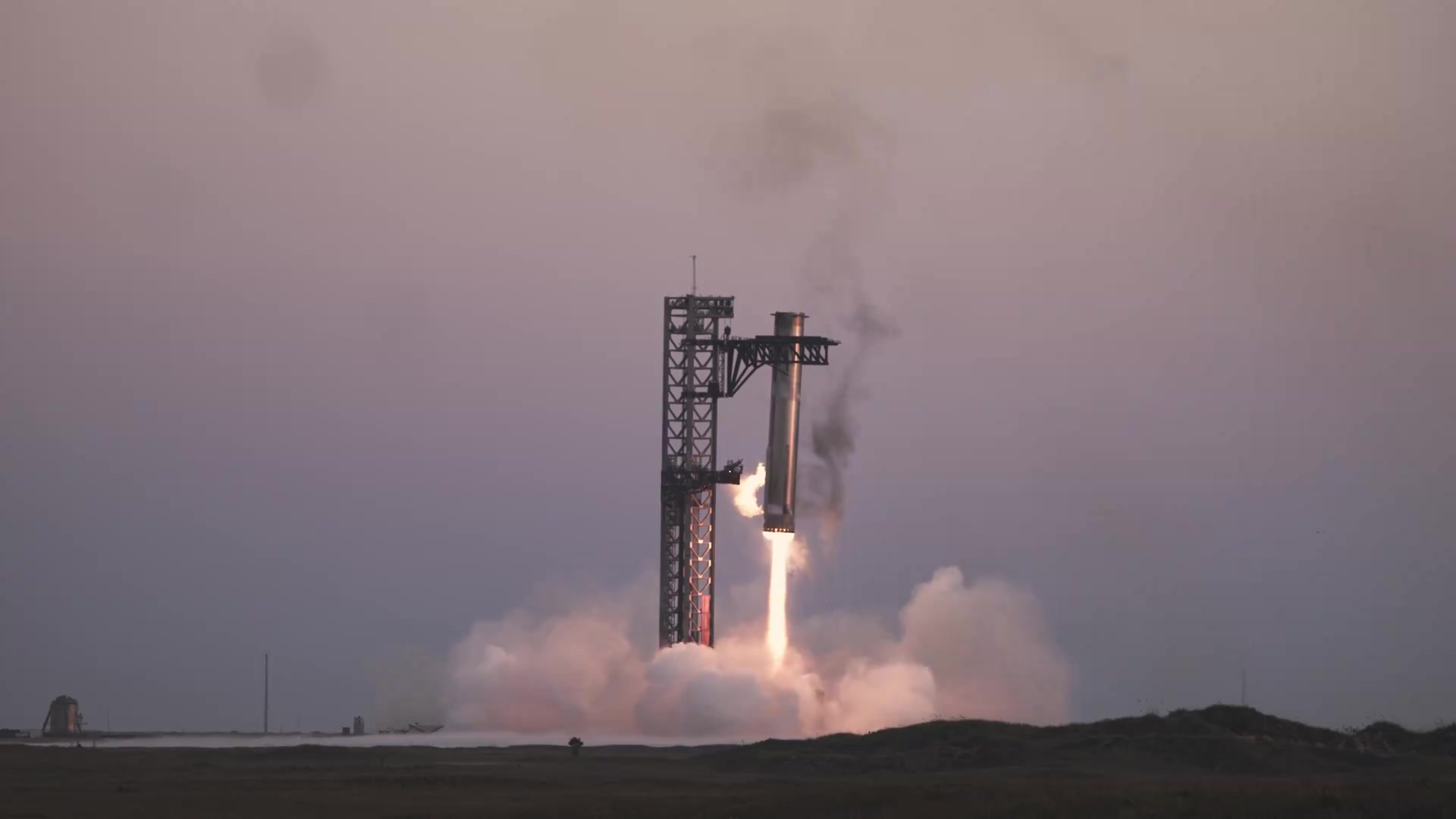 SpaceX Super Heavy booster caught by the Mechazilla chopsticks at Starbase